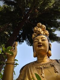 Low angle view of statue against trees