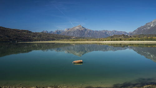 Scenic view of lake and mountains against sky