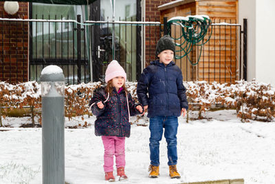 Boy and girl in snow during winter