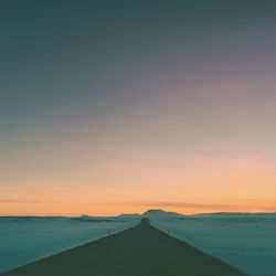 Scenic view of sea against clear sky during sunset