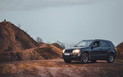 Off-road car in a suitable environment. hills, mountains and skies.