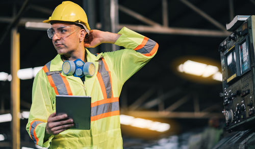 Man using mobile phone at construction site