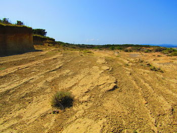 Scenic view of land against clear blue sky