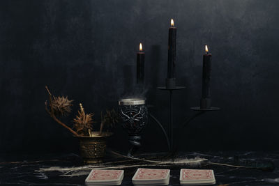 Mystic still life with voodoo doll, the tarot cards, books, evil candles and witchcraft objects. 