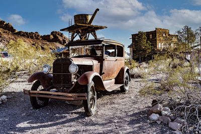 Abandoned car on field