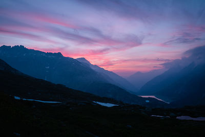 Scenic view of mountains against sky at sunset