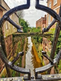 Canal seen through metal fence