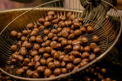 Close-up of chestnut roasting in container