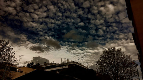 Low angle view of building against cloudy sky