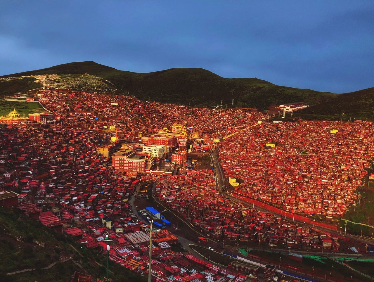 architecture, high angle view, crowd, built structure, group of people, mountain, building exterior, sky, nature, day, crowded, large group of people, outdoors, building, real people, city, residential district, autumn, food and drink, spectator