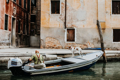 Man in boat against canal