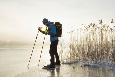 Man ice-skating on frozen lake