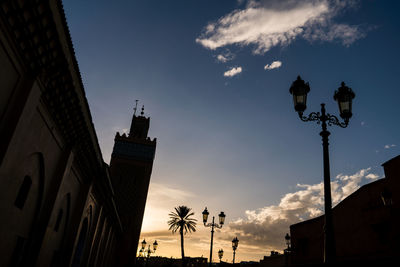 Low angle view of silhouette buildings against sky