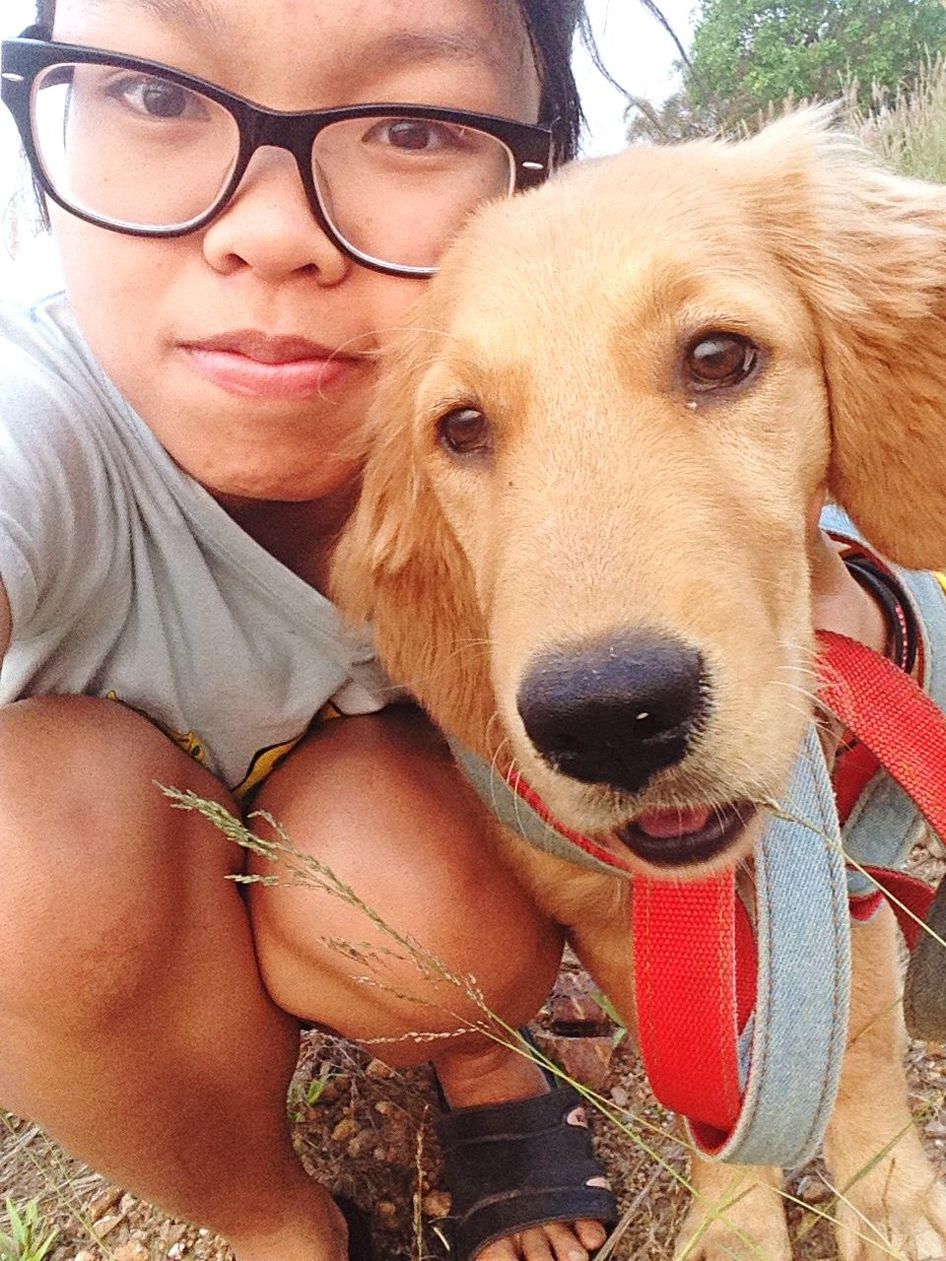 portrait, looking at camera, dog, pets, domestic animals, animal themes, one animal, mammal, lifestyles, leisure activity, person, front view, close-up, young adult, pet owner, sitting, smiling, mouth open