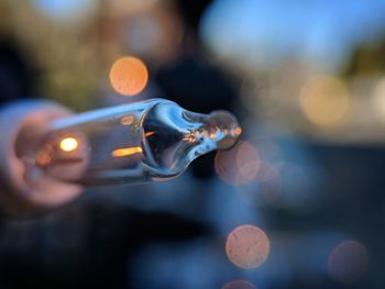 Close-up of hand holding cigarette