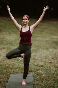 Full length of young woman standing on field