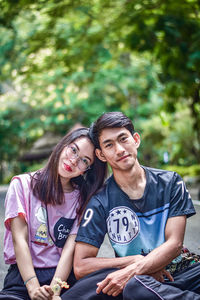 Portrait of a young couple sitting outdoors