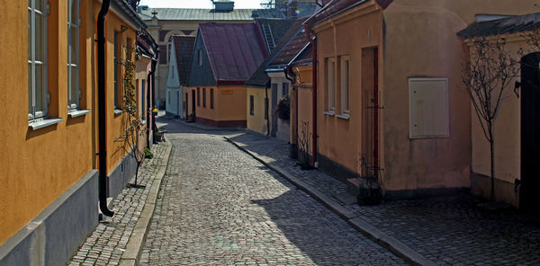 Empty alley amidst buildings in city