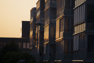 Buildings in city during sunset