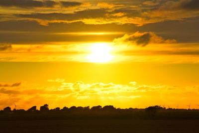 Scenic view of silhouette landscape against romantic sky at sunset