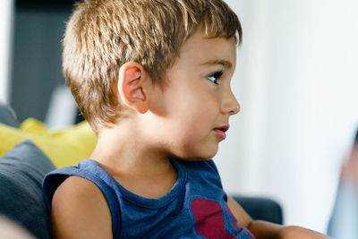 Close-up portrait of boy looking away at home