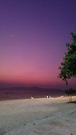 Scenic view of sea against clear sky at sunset