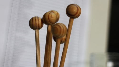 Close-up of wooden objects by curtain at home