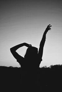 Close-up of silhouette woman against clear sky