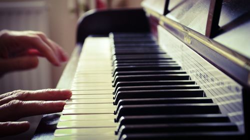 Close-up of hands playing the piano