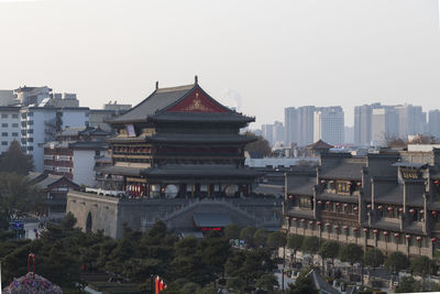 Buildings in city against clear sky