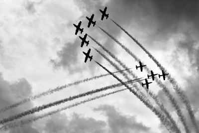 Low angle view of airplane flying against sky