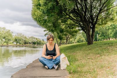 Portrait of woman sitting on field