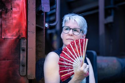 Portrait of woman sitting on metal