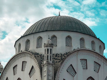 Low angle view of a building against cloudy sky