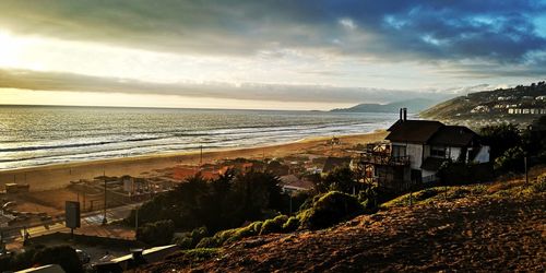 Scenic view of beach against sky during sunset