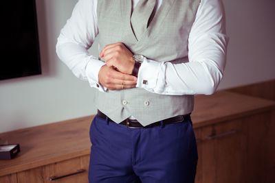 Midsection of man standing at home