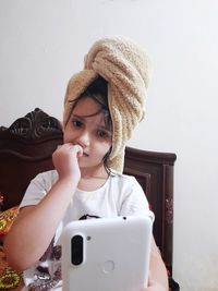 Portrait of smiling woman using smart phone at home