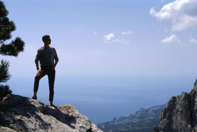 Rear view of man standing on rock