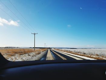 Railroad tracks seen through car windshield