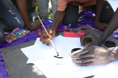 High angle view of people working on table