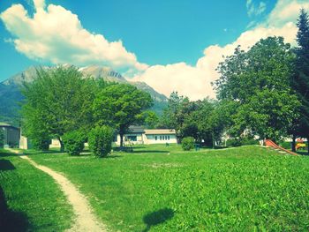 Scenic view of grassy field against cloudy sky