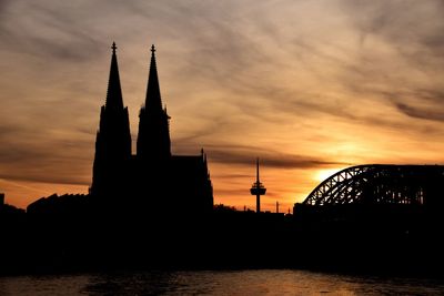 Silhouette of clock tower at sunset