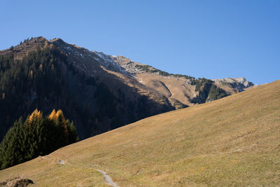 Scenic view of mountains against clear blue sky