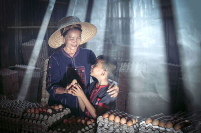 Mother and son selling eggs in market