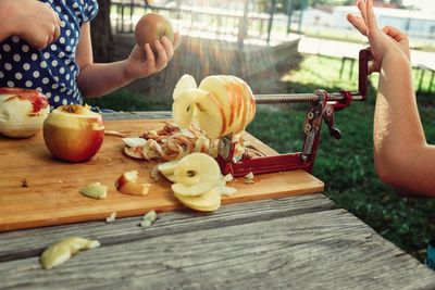 Midsection of woman preparing food on table