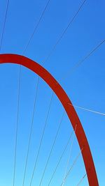 Low angle view of bridge against clear blue sky