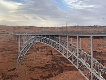 Arch bridge over water against sky