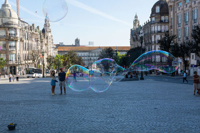 View of bubbles in city against sky