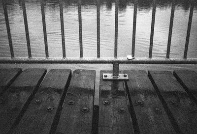 High angle view of railing by water