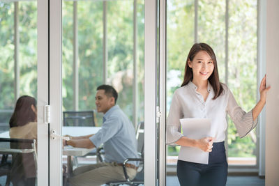 Young couple standing by window